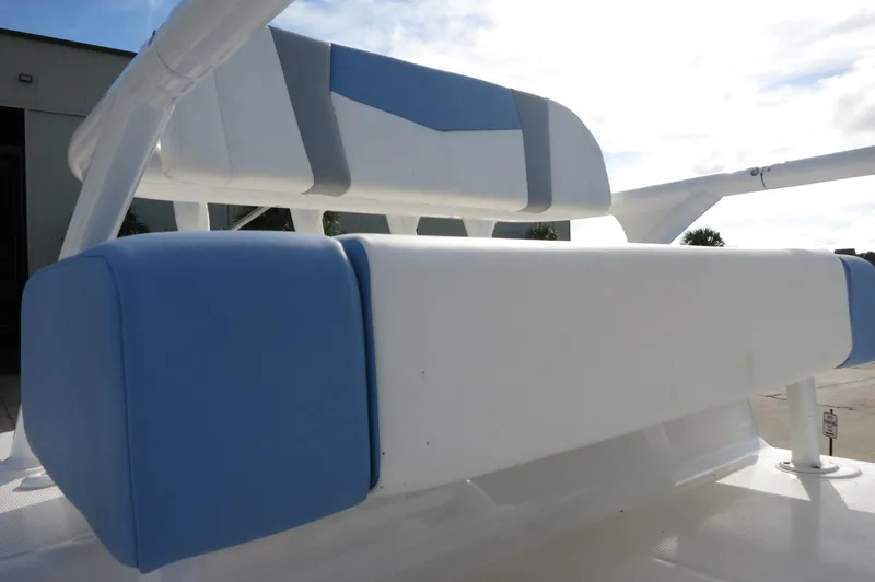 Slide: The Image of 2024 Robalo R266 Skydeck boat seating with blue and white cushions. - 22