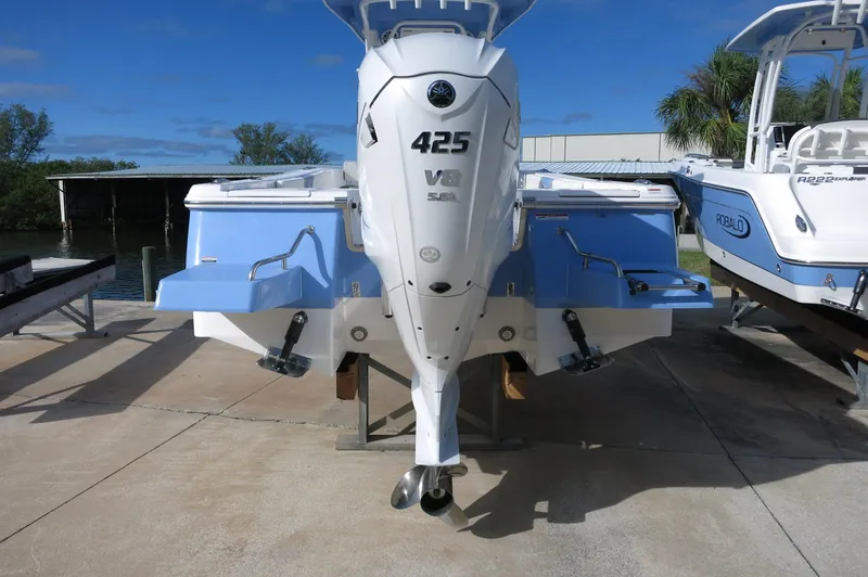 Slide: The Image of 2024 Robalo R266 Skydeck boat with a 425 V8 engine, docked on a sunny day. - 3