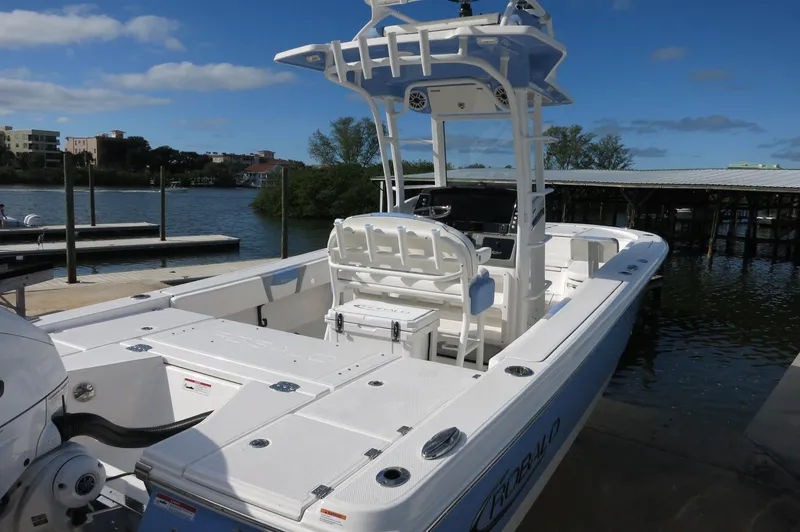 Slide: The Image of 2024 Robalo R266 Skydeck boat docked by the water on a sunny day. - 5