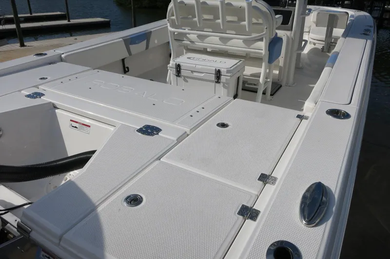 Slide: The Image of 2024 Robalo R266 Skydeck boat interior with seating and storage compartments. - 7