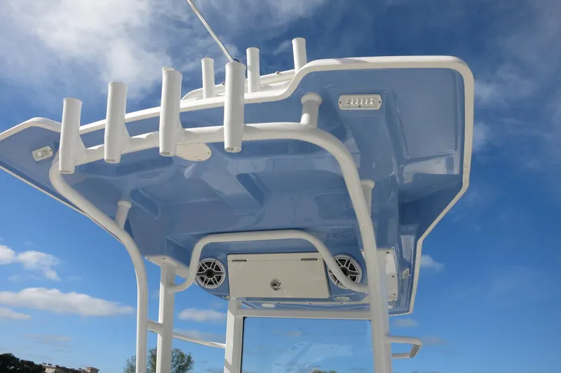 Slide: The Image of 2024 Robalo R266 Skydeck boat top view with rod holders and speakers. - 8