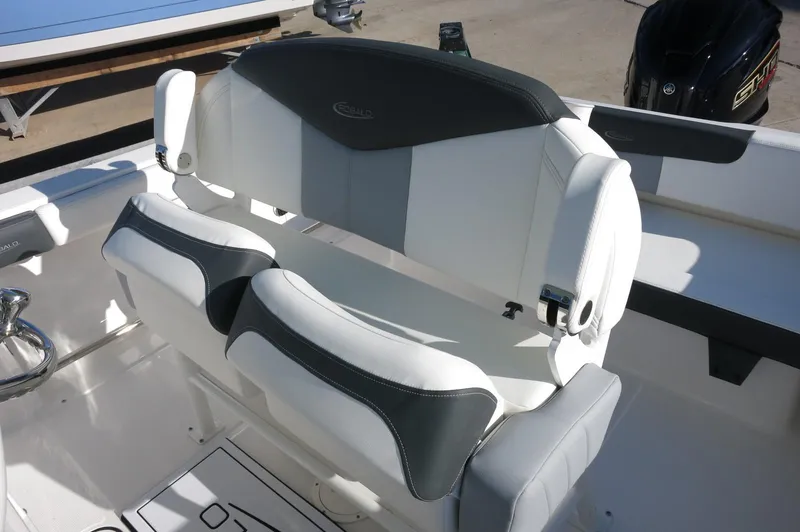 Slide: The Image of 2024 Robalo 222 Explorer CC boat seating area with cushioned seats. - 22