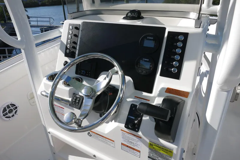 Slide: The Image of 2024 Robalo 222 Explorer CC center console dashboard with steering wheel and controls. - 25
