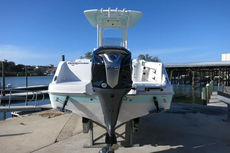 Slide: The Image of 2024 Robalo 222 Explorer CC boat docked at a marina. - 7
