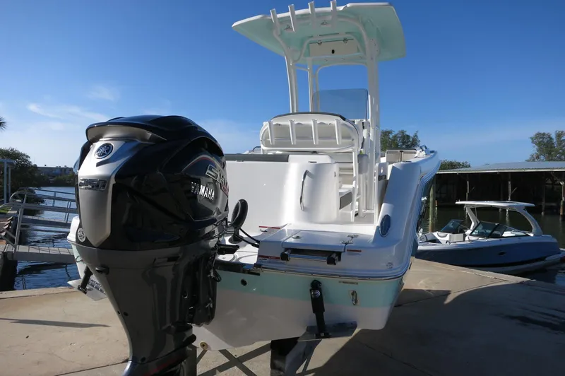 Slide: The Image of 2024 Robalo 222 Explorer CC boat with Yamaha outboard motor docked. - 8