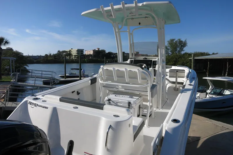 Slide: The Image of 2024 Robalo 222 Explorer CC boat docked by the water. - 9