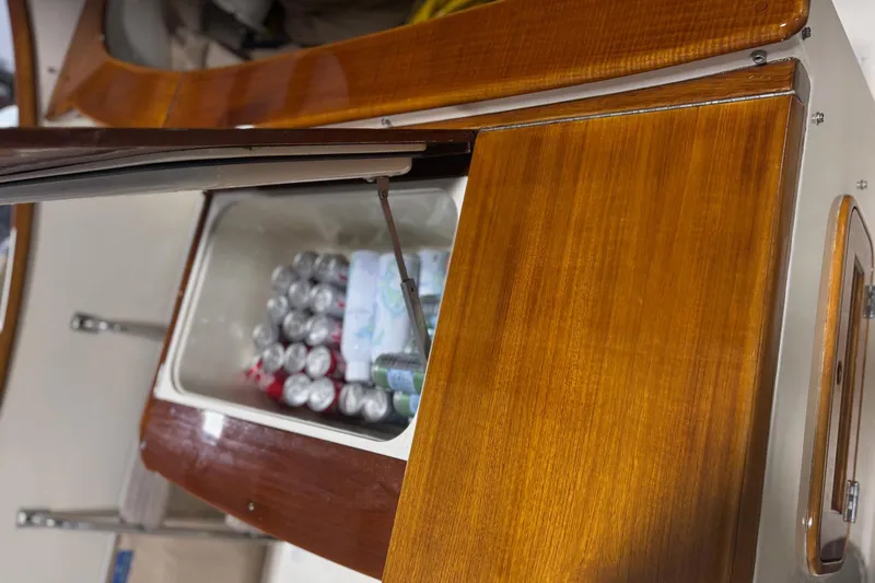 Slide: The Image of Hinckley 36 Picnic Boat EP 2003 with open wooden storage compartment, revealing drinks inside. - 10