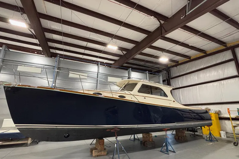 Slide: The Image of 2003 Hinckley 36 Picnic Boat EP in storage, showcasing elegant design and craftsmanship. - 2