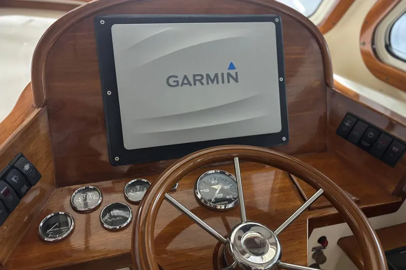 Slide: The Image of Hinckley 36 Picnic Boat EP 2003 dashboard with Garmin navigation system and gauges. - 5
