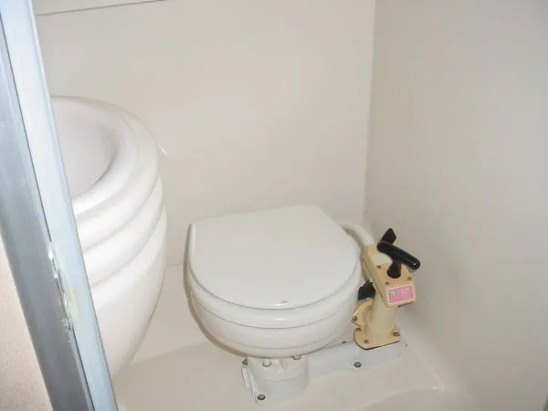 Slide: The Image of 1998 Maxum 3000SCR boat bathroom with compact marine toilet and sink. - 10