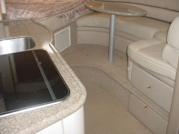 Slide: The Image of Interior of a 1998 Maxum 3000SCR boat with kitchenette and seating area. - 11