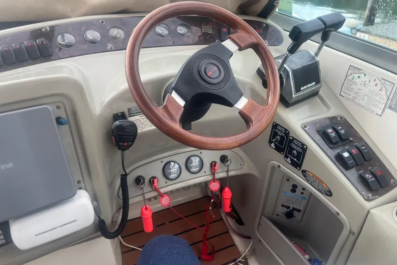 Slide: The Image of 1998 Maxum 3000SCR boat dashboard with steering wheel and control panel. - 30