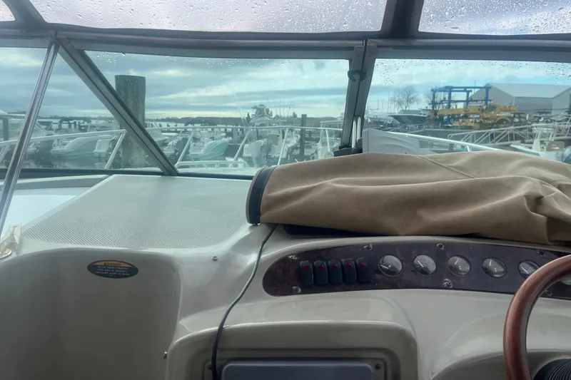 Slide: The Image of 1998 Maxum 3000SCR boat dashboard with marina view through windshield. - 31