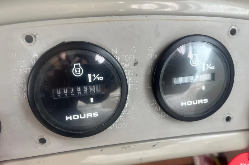 Slide: The Image of Hour meters on a 1998 Maxum 3000SCR boat dashboard, displaying usage hours. - 35