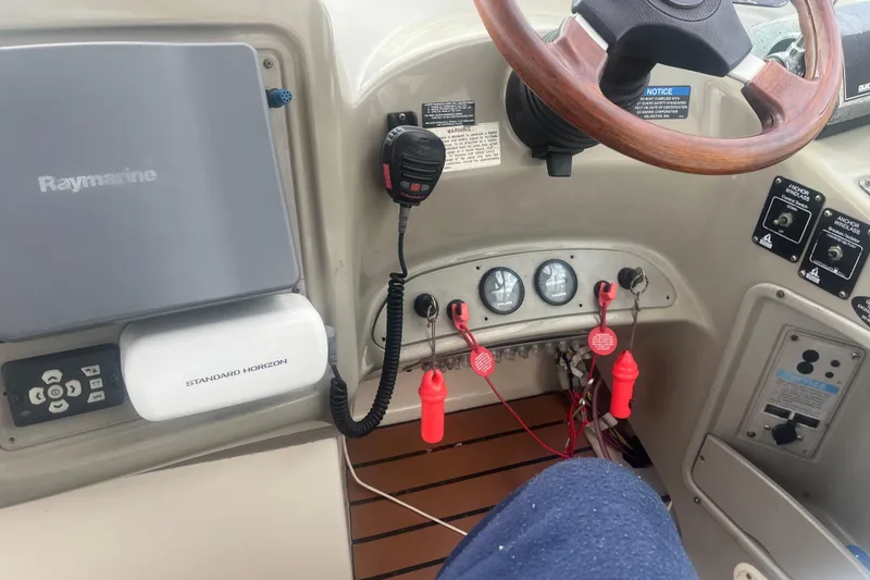 Slide: The Image of 1998 Maxum 3000SCR boat dashboard with Raymarine and Standard Horizon equipment. - 37