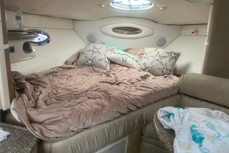 Slide: The Image of Cozy cabin interior of 1998 Maxum 3000SCR boat with plush bedding and decorative pillows. - 38