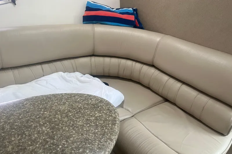Slide: The Image of Interior of 1998 Maxum 3000SCR boat with beige leather seating and a granite-style table. - 43