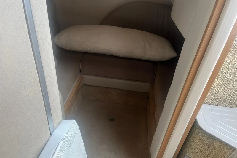 Slide: The Image of 1998 Maxum 3000SCR cabin interior with a cozy sleeping area and pillow. - 51