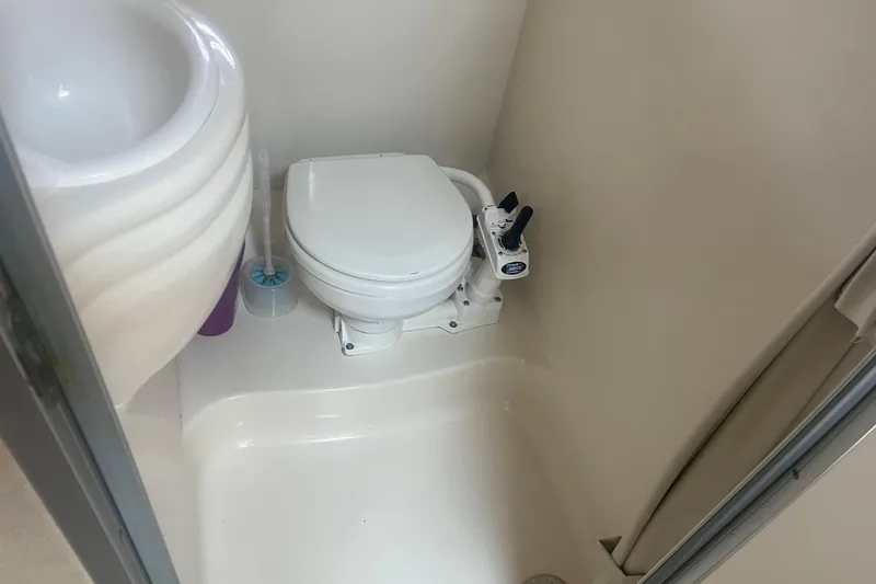 Slide: The Image of Compact bathroom in 1998 Maxum 3000SCR boat with toilet and sink. - 52