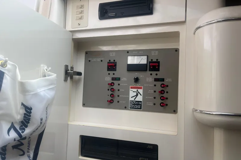 Slide: The Image of Electrical control panel on a 1998 Maxum 3000SCR boat, featuring switches and gauges. - 53