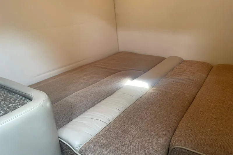 Slide: The Image of 1998 Maxum 3000SCR interior cabin with beige upholstery and soft lighting. - 55