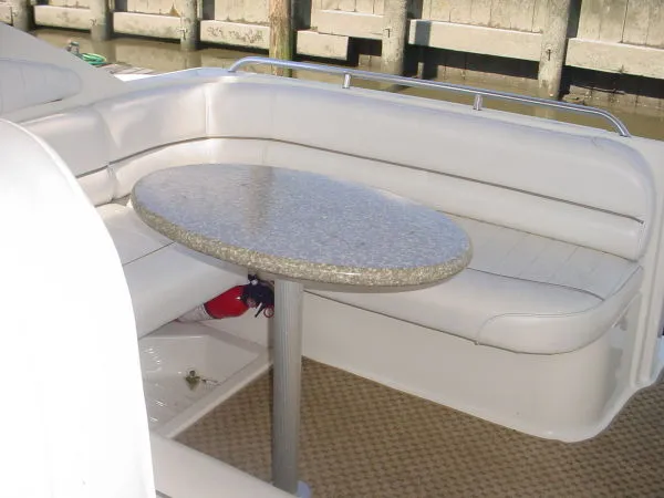 Slide: The Image of 1998 Maxum 3000SCR boat interior with cushioned seating and round table. - 6