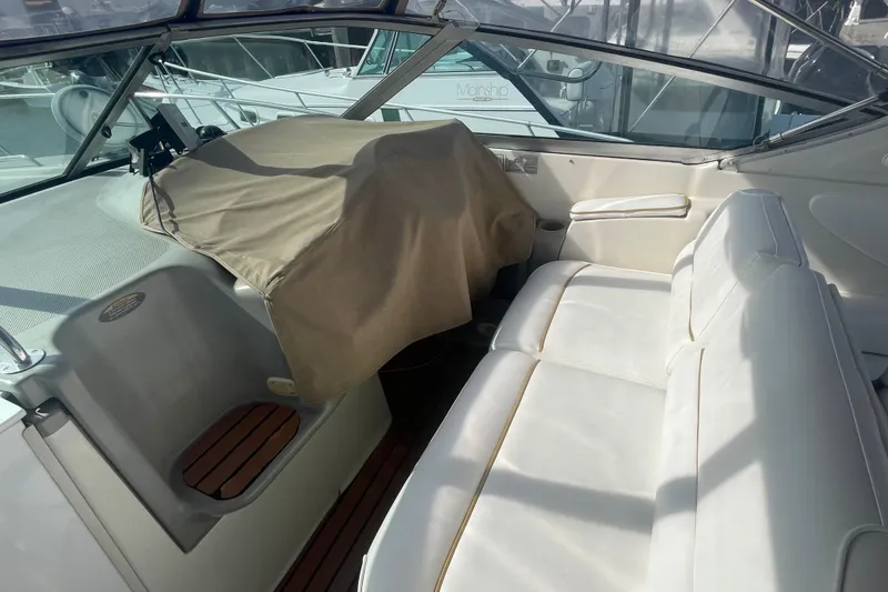 Slide: The Image of 1998 Maxum 3000SCR boat interior with white seating and covered dashboard. - 61