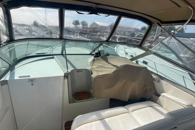 Slide: The Image of 1998 Maxum 3000SCR boat interior with covered helm and seating area. - 63