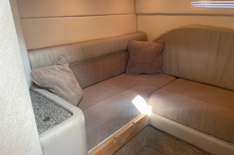 Slide: The Image of Cozy interior seating area in a 1998 Maxum 3000SCR boat. - 66