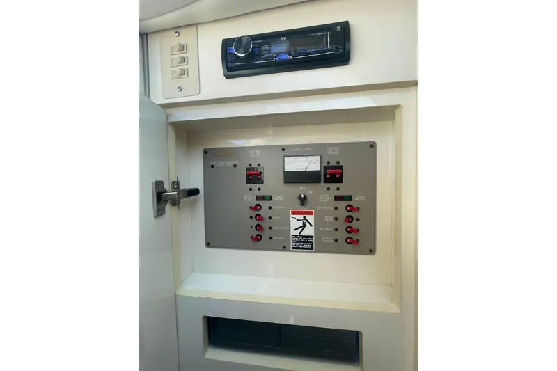 Slide: The Image of 1998 Maxum 3000SCR boat control panel with switches and stereo system. - 71