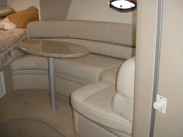 Slide: The Image of 1998 Maxum 3000SCR interior with beige leather seating and a round table. - 8