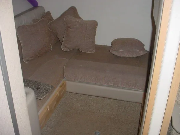 Slide: The Image of Interior seating area of a 1998 Maxum 3000SCR boat with brown cushions. - 9