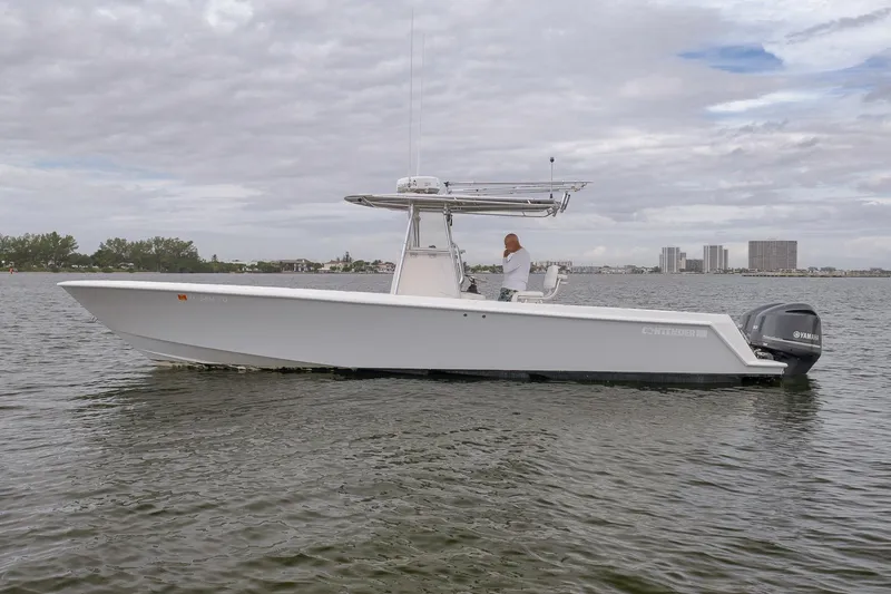 Slide: The Image of 2012 Contender 32 Tournament boat on calm water, overcast sky. - 11