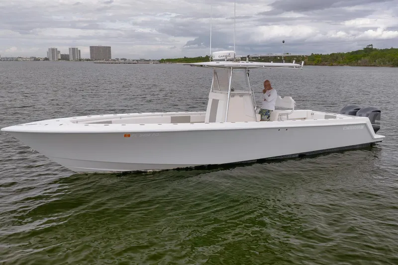 Slide: The Image of 2012 Contender 32 Tournament boat on calm water with a person onboard. - 12