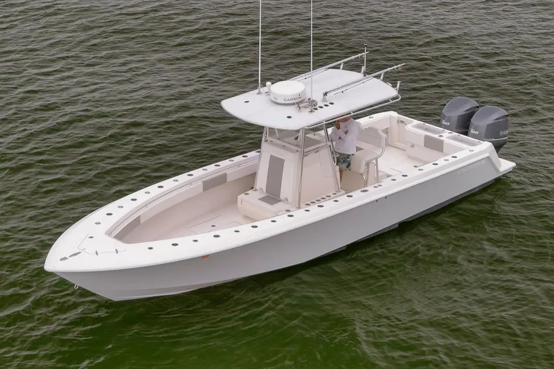 Slide: The Image of 2012 Contender 32 Tournament boat on water, featuring dual outboard engines. - 14