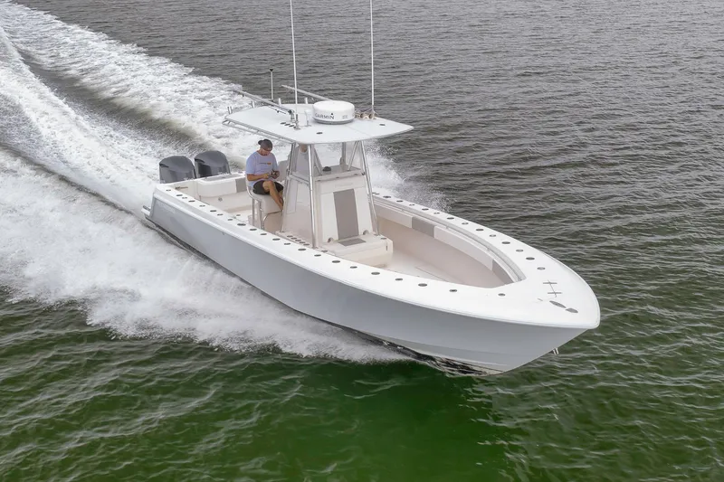 Slide: The Image of 2012 Contender 32 Tournament boat cruising on open water, side view. - 15