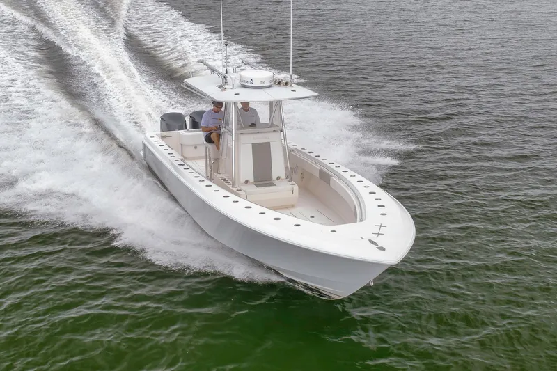 Slide: The Image of 2012 Contender 32 Tournament boat speeding on water, showcasing sleek design and performance. - 16