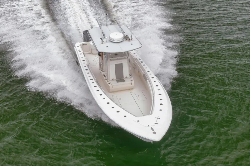 Slide: The Image of 2012 Contender 32 Tournament boat speeding on open water. - 17