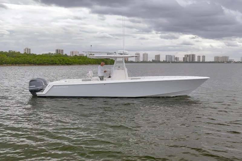 Slide: The Image of 2012 Contender 32 Tournament boat on water with city skyline in background. - 2