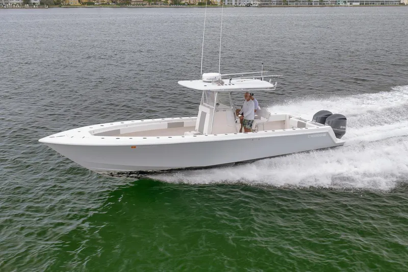 Slide: The Image of 2012 Contender 32 Tournament boat cruising on open water. - 20