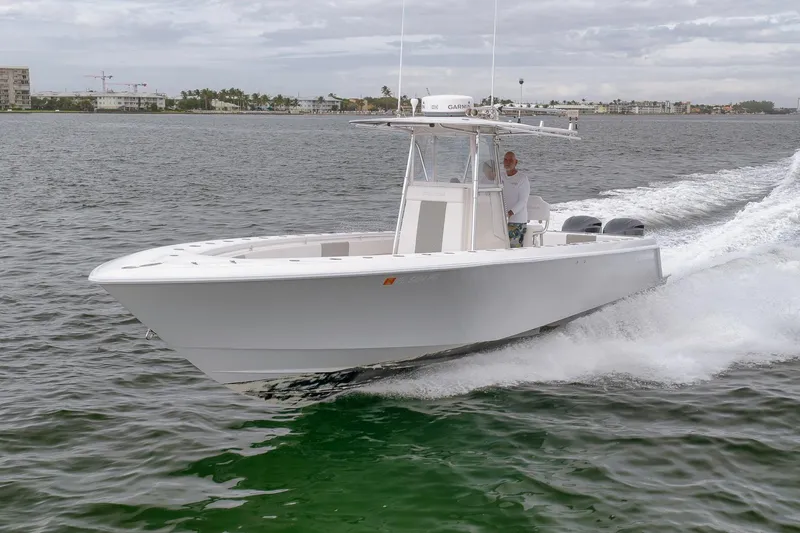 Slide: The Image of 2012 Contender 32 Tournament boat cruising on open water. - 21