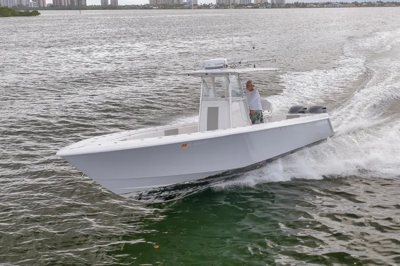 Slide: The Image of 2012 Contender 32 Tournament boat cruising on open water. - 25