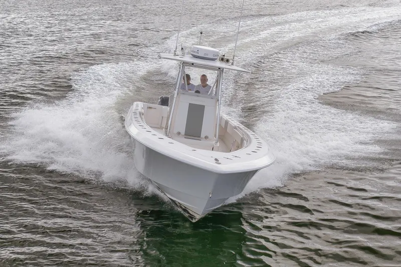 Slide: The Image of 2012 Contender 32 Tournament boat cruising on open water. - 26