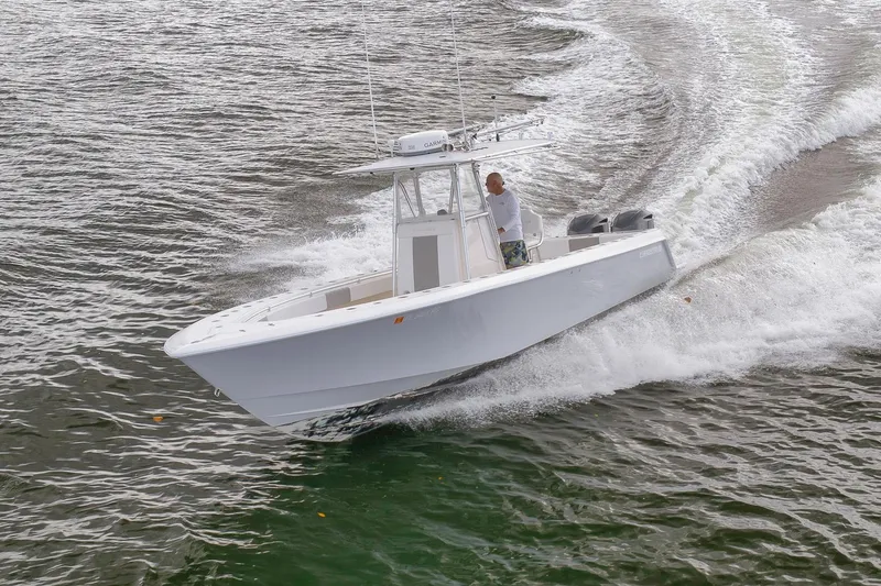 Slide: The Image of 2012 Contender 32 Tournament boat cruising on water, creating waves. - 27
