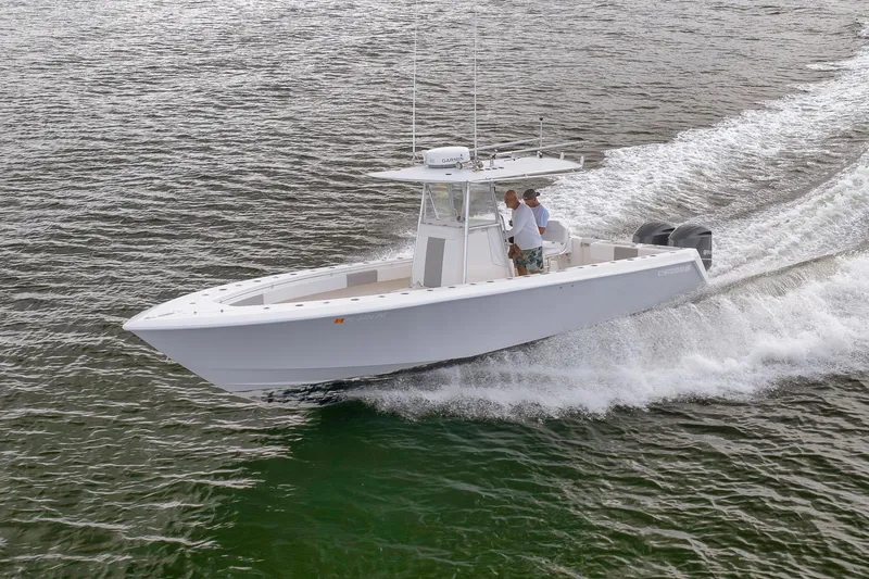 Slide: The Image of 2012 Contender 32 Tournament boat cruising on open water. - 28