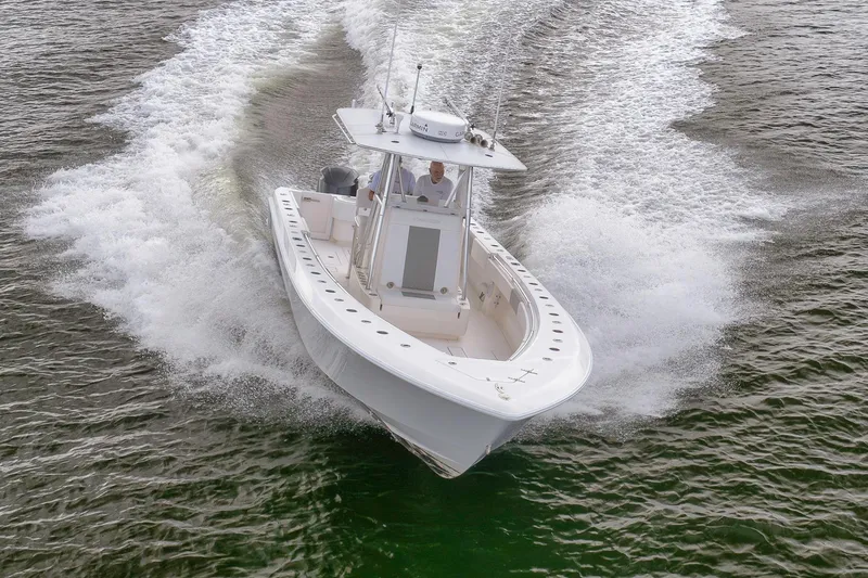 Slide: The Image of 2012 Contender 32 Tournament boat cruising on open water, creating a dynamic wake. - 29