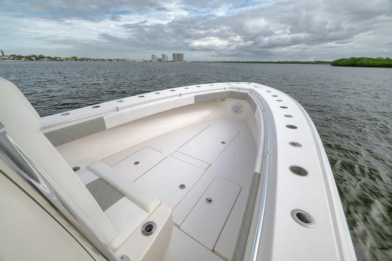 Slide: The Image of 2012 Contender 32 Tournament boat on water, featuring spacious deck and sleek design. - 32