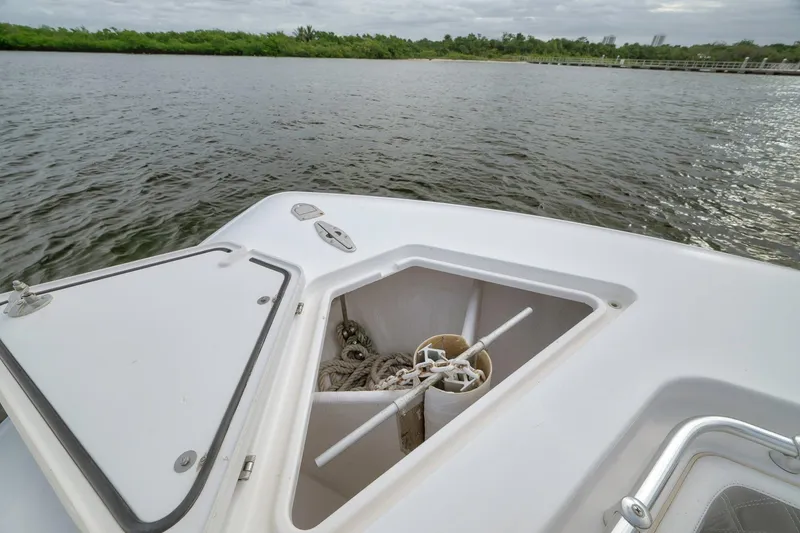 Slide: The Image of 2012 Contender 32 Tournament boat with open anchor storage, near calm waters. - 33
