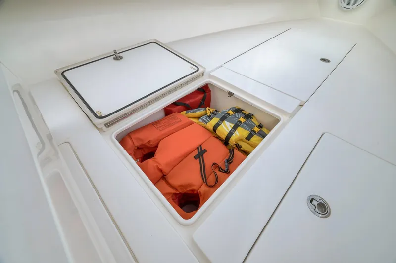 Slide: The Image of Storage compartment with life jackets on a 2012 Contender 32 Tournament boat. - 39