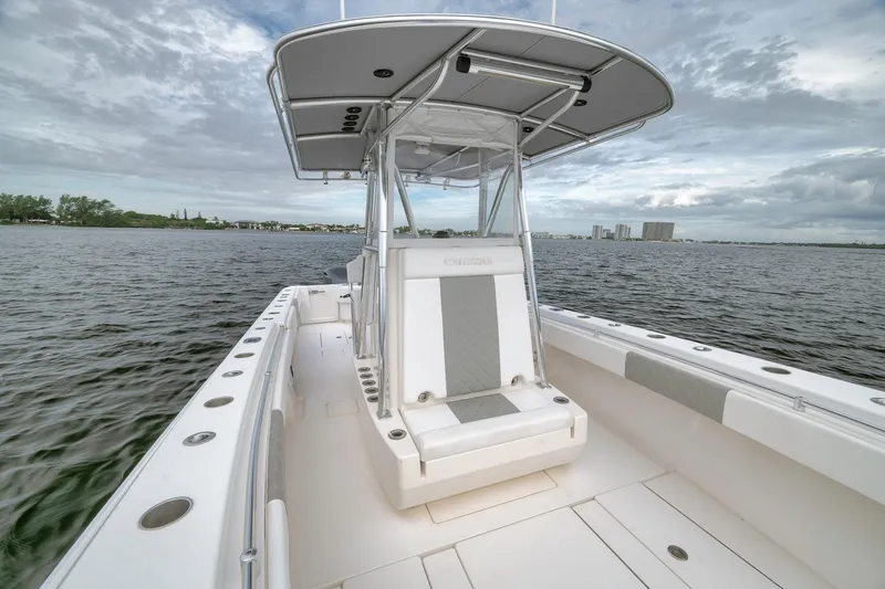 Slide: The Image of 2012 Contender 32 Tournament boat on water, featuring sleek design and spacious deck. - 48